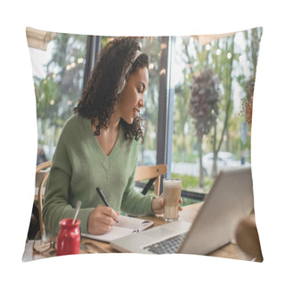 Personality  African American Woman Listening Podcast In Headphones And Holding Glass With Coffee Near Laptop In Cafe  Pillow Covers