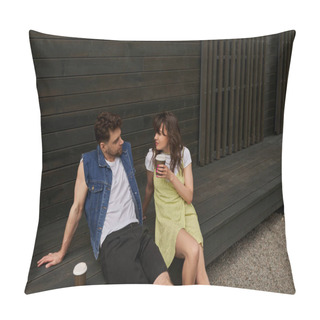 Personality  Stylish Brunette Woman In Sundress Holding Takeaway Coffee And Looking At Bearded Boyfriend In Denim Vest While Sitting Near Wooden House In Rural Setting, Carefree Moments Concept Pillow Covers