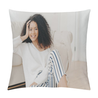 Personality  Lovely Dark Skinned Woman With Crisp Hair, Sits On Floor Near Sofa, Wears White Sweater And Striped Trousers, Enjoys Positive Emotions, Enjoys Weekend At Home. People, Rest, Happiness Concept Pillow Covers