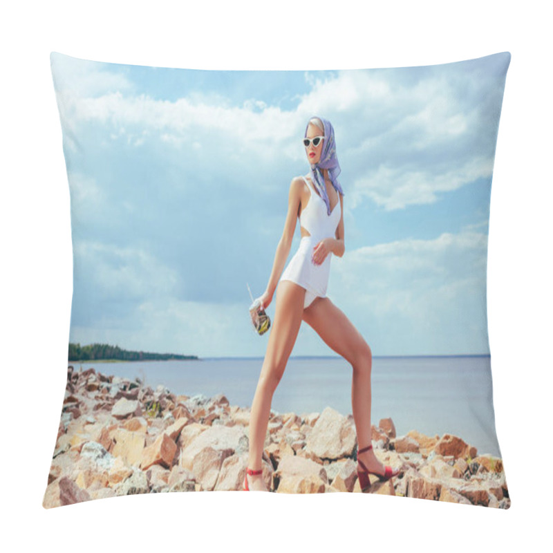 Personality  attractive girl in white vintage swimwear holding mason jar with fresh cocktail and posing on rocky beach pillow covers