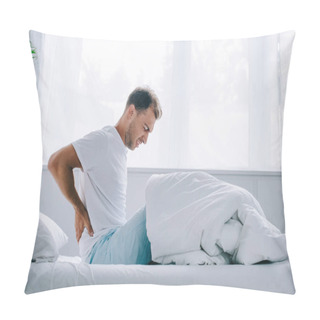 Personality  Side View Of Young Man In Pajamas Sitting On Bed And Suffering From Back Pain Pillow Covers