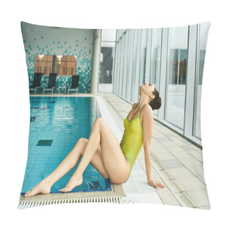 Personality  A Brunette Woman In A Yellow Bathing Suit Lounging On The Edge Of An Indoor Swimming Pool. Pillow Covers