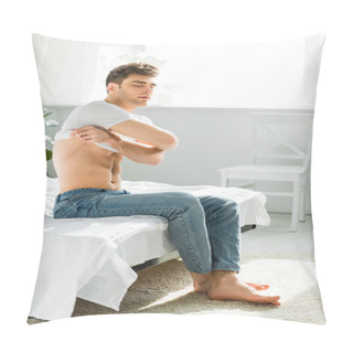 Personality  Handsome Man In Blue Jeans Sitting On Bed Near Window And Taking Off T-shirt In Bedroom Pillow Covers