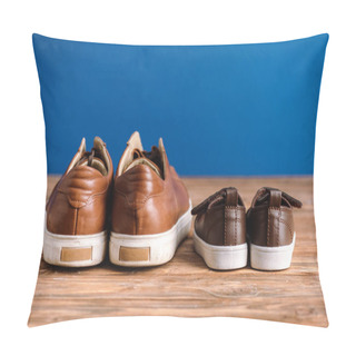 Personality  Mens And Childrens Brown Casual Shoes On Textured Wooden Surface Isolated On Blue, Fathers Day Concept Pillow Covers