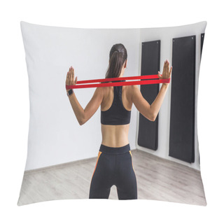 Personality  Back View Of Athletic Body Fitness Beautiful Woman In Black Top And Orange Leggings Performing Exercises For Muscles Of Back And Hands With Resistance Band While Standing In Gym Pillow Covers