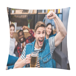 Personality  Excited Young Man Holding Glass Of Beer And Watching Tv With Friends Sitting Behind Pillow Covers