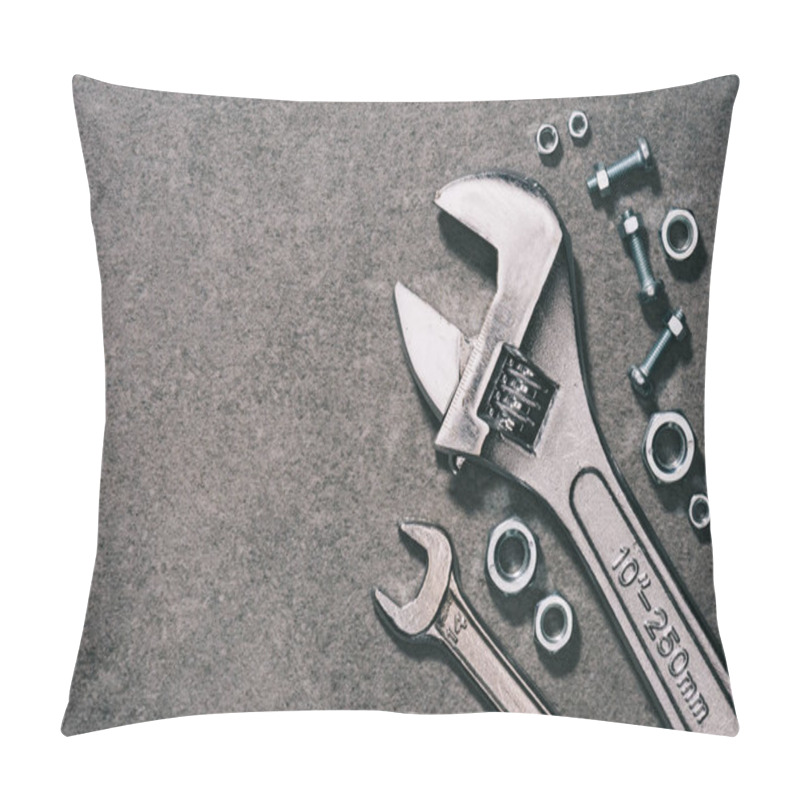 Personality  top view of monkey wrench, wrench and nuts on grey surface pillow covers