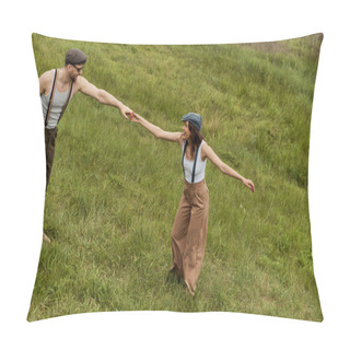 Personality  Side View Of Positive And Fashionable Couple In Newsboy Caps And Suspenders Holding Hands And Having Fun On Grassy Meadow At Background, Stylish Couple Enjoying Country Life Pillow Covers