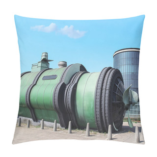 Personality  A Green Submarine, Resembling A Movie Prop, Is Displayed Outdoors Next To A Modern Glass Building, Attracting Passersby With Its Futuristic Design, Creating A Sci-fi Scene. Pillow Covers