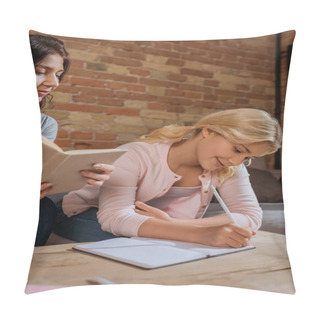 Personality  Selective Focus Of Woman Holding Book While Kid Writing On Notebook On Coffee Table At Home  Pillow Covers