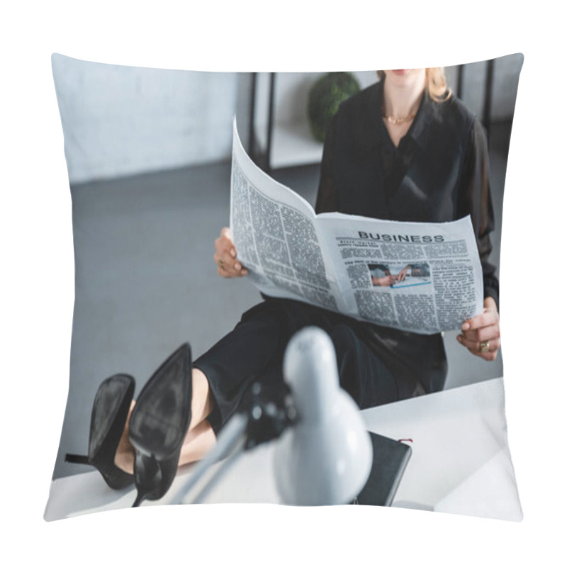 Personality  cropped view of businesswoman in black clothes sitting at table and reading newspaper pillow covers