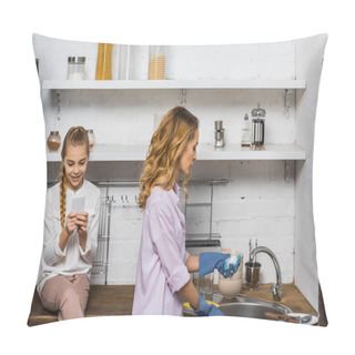 Personality  Attractive Woman In Rubber Gloves Washing Up While Daughter Sitting On Table And Using Smartphone In Kitchen Pillow Covers