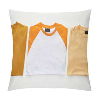 Personality  Top View Of Ochre, Beige And Orange Folded T-shirts On White Background Pillow Covers