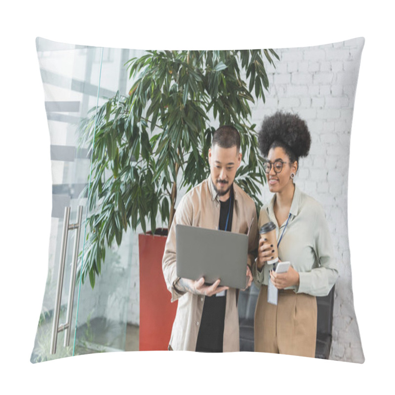 Personality  happy african american businesswoman holding smartphone and looking at laptop of asian coworker pillow covers