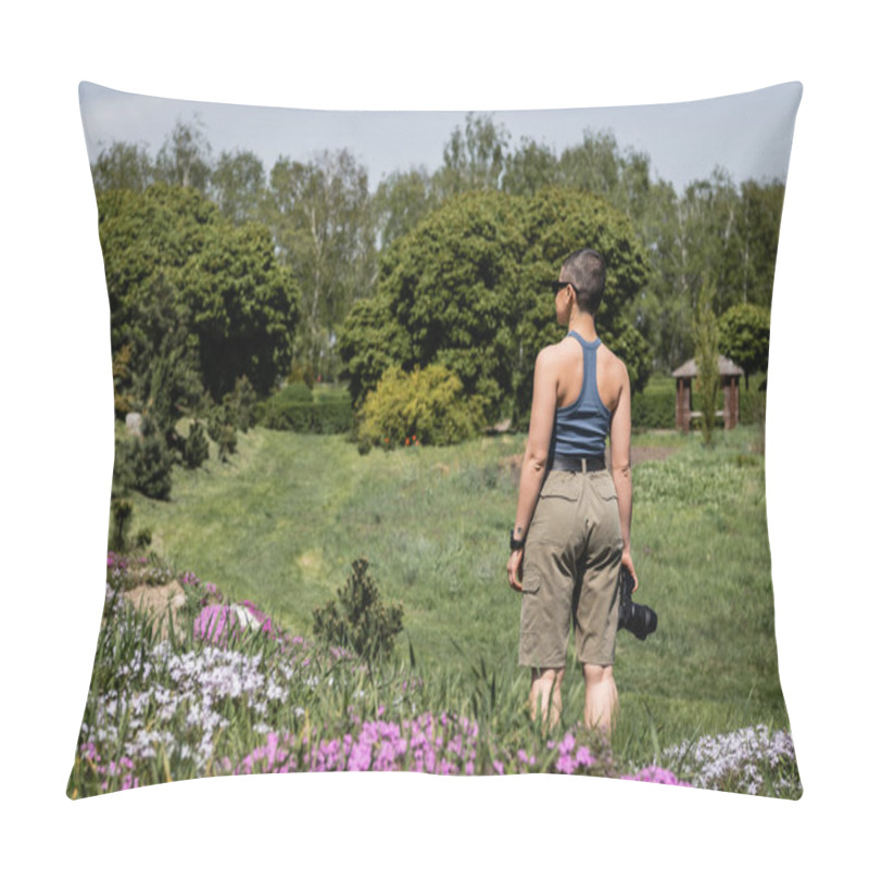 Personality  Side View Of Young Short Haired And Tattooed Female Hiker In Sunglasses Holding Digital Camera While Standing On Lawn With Flowers And Nature At Background, Connecting With Nature Concept Pillow Covers