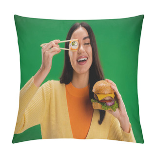 Personality  Cheerful Woman With Tasty Burger Holding Sushi Roll Near Eye Isolated On Green Pillow Covers