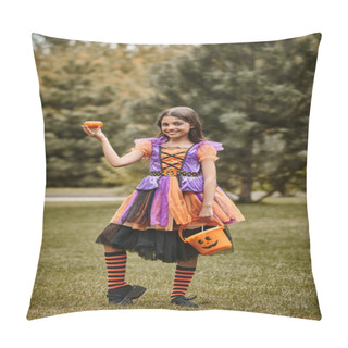 Personality  Cheerful Girl In Halloween Costume Holding Pumpkin And Bucket Of Candies On Green Grass Pillow Covers