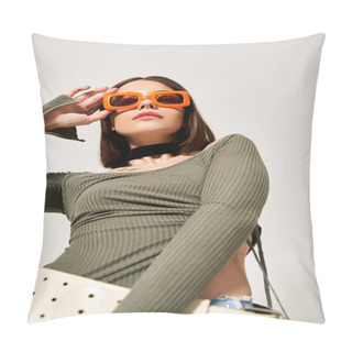 Personality  A Young Woman With Brunette Hair Posing In A Studio Setting Wearing A Vibrant Green Top And Trendy Orange Sunglasses. Pillow Covers