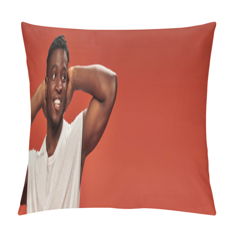 Personality  smiley and hot african american guy standing with hands behind head and looking away on red, banner pillow covers