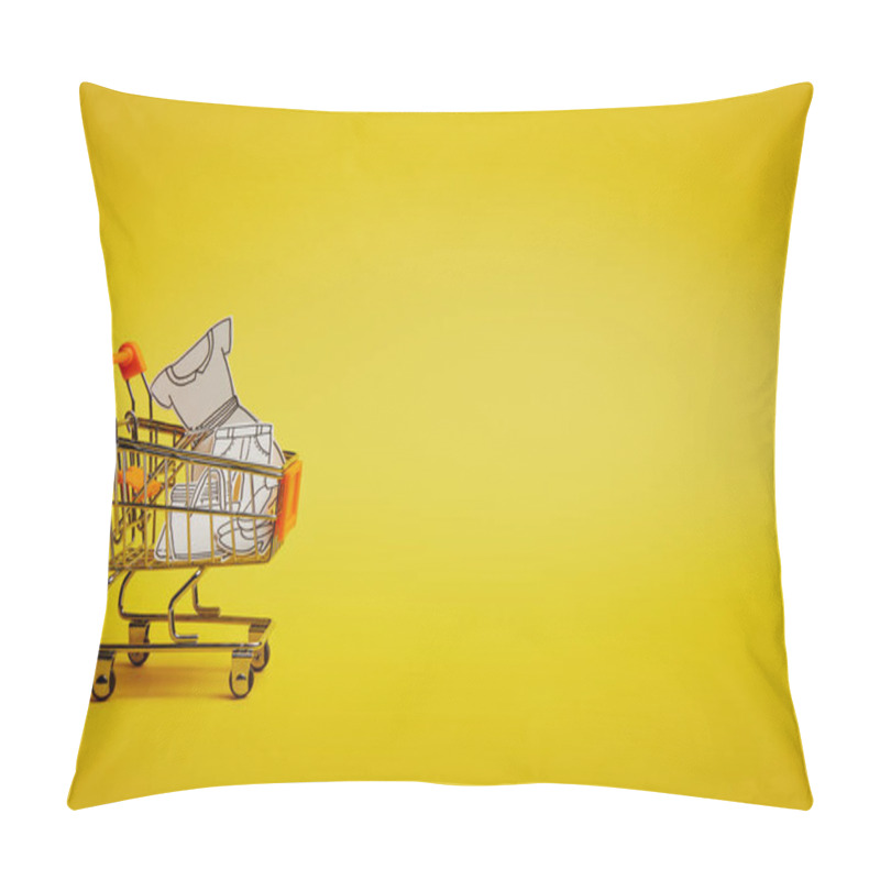 Personality  close up view of little shopping trolley with paper clothes on yellow backdrop pillow covers