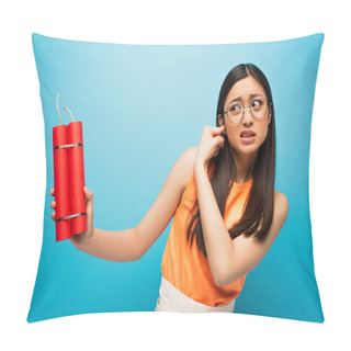 Personality  Stressed Asian Girl In Glasses Covering Ear And Holding Dynamite Sticks On Blue Pillow Covers