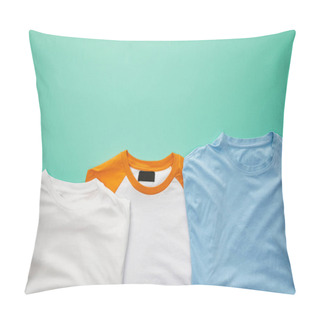 Personality  Top View Of Folded Plaid Color T-shirts On Turquoise Background Pillow Covers