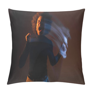 Personality  Motion Blur Of African American Man With Bipolar Disorder And Injured Face Screaming With Closed Eyes On Dark Background With Orange And Blue Light Pillow Covers