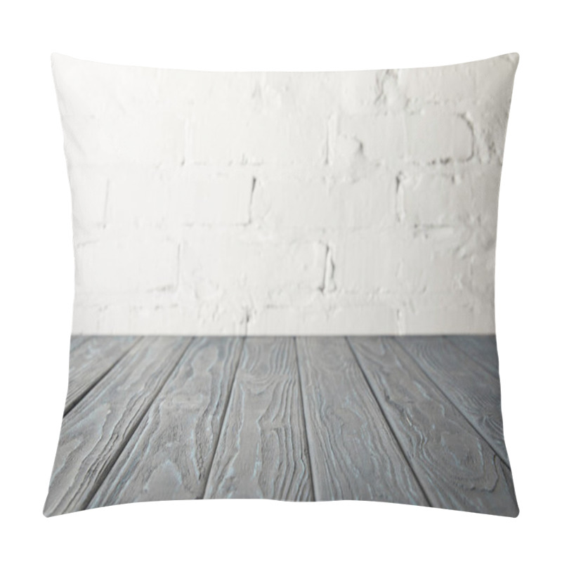 Personality  grey wooden tabletop and white wall with bricks pillow covers