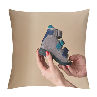 Personality  Female Is Holding Close-up A Special Children's Orthopedic Shoe Sandals Made Of Genuine Leather. Comfortable Shoes Isolated On Light Background With Copyspace. Image Suitable For Advertising. Pillow Covers