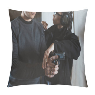 Personality  Cropped Image Of Instructor Describing Client How To Hold Gun Pillow Covers