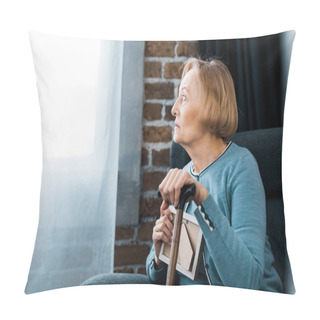 Personality  Upset Senior Woman Sitting With Walking Stick And Holding Picture Frame At Home Pillow Covers