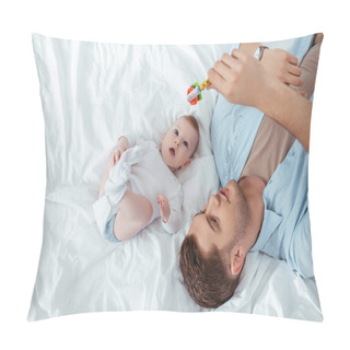 Personality  Top View Of Young Father Playing With Baby Rattle Over Cute Little Son Lying In Bed Pillow Covers