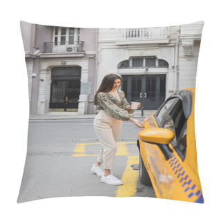 Personality  Chic Woman With Long Hair Holding Coffee In Paper Cup While Standing In Trendy Outfit With Handbag On Chain Strap And Opening Door Of Yellow Cab On Blurred Urban Street  Pillow Covers