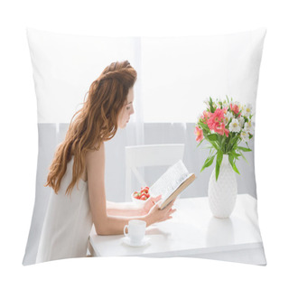 Personality  Focused Young Woman Reading Book While Sitting At Table With Coffee Cup And Flowers In Vase Pillow Covers