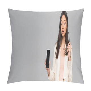 Personality  Horizontal Image Of Thoughtful Asian Businesswoman Holding Eyeglasses While Showing Smartphone With Blank Screen Isolated On Grey Pillow Covers