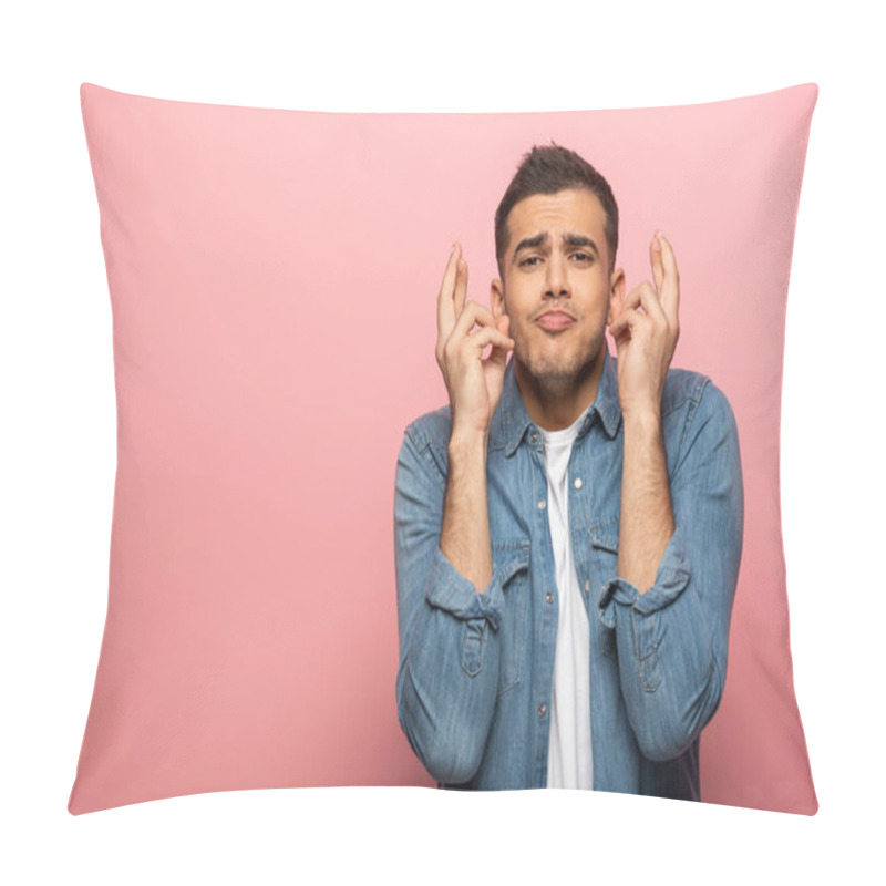 Personality  Handsome man with facial expression and crossed fingers looking at camera on pink background pillow covers