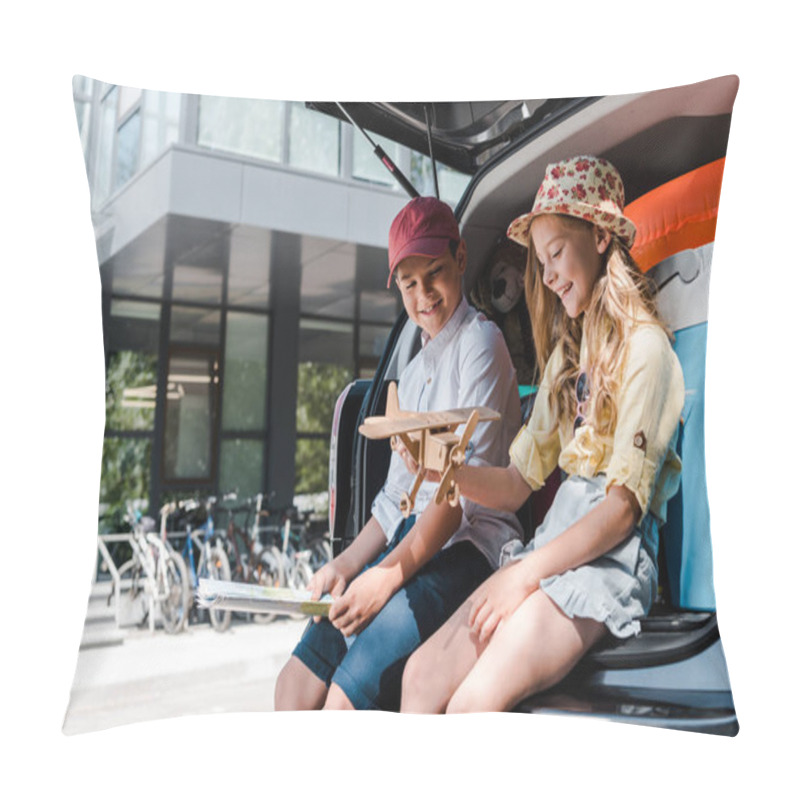 Personality  happy brother and cheerful sister looking at toy biplane near car and building  pillow covers