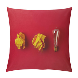 Personality  Top View Of Crumpled Yellow Papers With Incandescent Lamp On Red Surface Pillow Covers