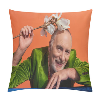 Personality  Happy Aging Concept, Delighted And Bearded Senior Man In Green Velvet Blazer Sitting At Table With Blue Velour Cloth And Holding White Orchid Flower Above Head On Vibrant Orange Background Pillow Covers