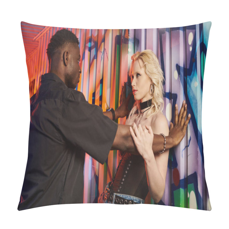Personality  A blonde woman and an African American man standing together in front of a vibrant graffiti wall on an urban street. pillow covers