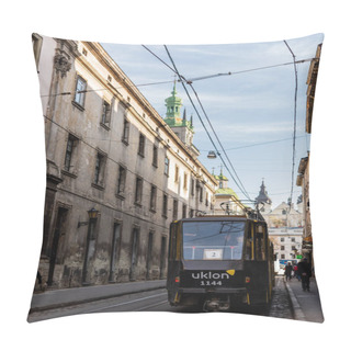 Personality  LVIV, UKRAINE - OCTOBER 23, 2019: Tram With Uklon Lettering On Narrow Street In City Center Pillow Covers