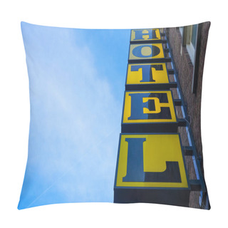Personality  Neon Hotel Sign On The Building Corner Against Blue Sky.  Empty Copy Space For Inscription. Modern Yellow Sign. Vertical Hotel Sign. Amsterdam, Netherlands  Pillow Covers