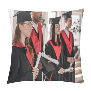 Personality  Happy Student Near Interracial Classmates In Graduation Gowns And Caps Holding Diploma On Blurred Background  Pillow Covers