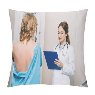 Personality  Beautiful Young Doctor Looking At Clipboard While Standing Near Patient During Mammography Test On X-ray Machine Pillow Covers
