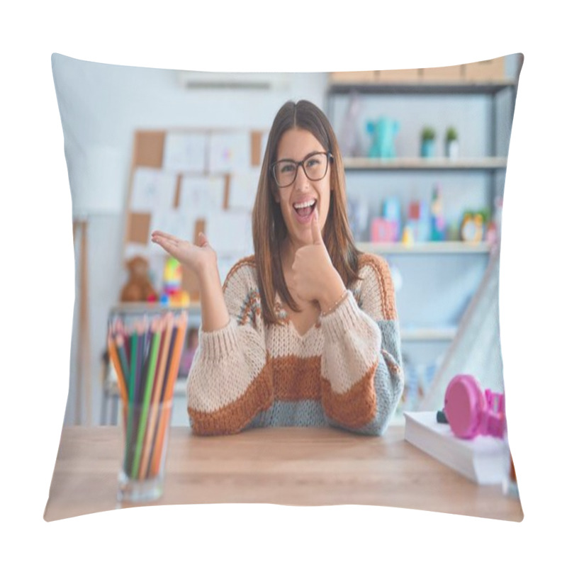 Personality  Young Beautiful Teacher Woman Wearing Sweater And Glasses Sitting On Desk At Kindergarten Showing Palm Hand And Doing Ok Gesture With Thumbs Up, Smiling Happy And Cheerful Pillow Covers