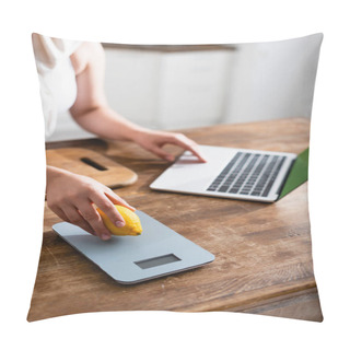 Personality  Cropped View Of Woman Holding Lemon Near Kitchen Scales And Using Laptop  Pillow Covers