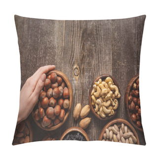 Personality  Partial View Of Woman Holding Bowl With Hazelnuts On Wooden Tabletop With Different Nuts Around Pillow Covers