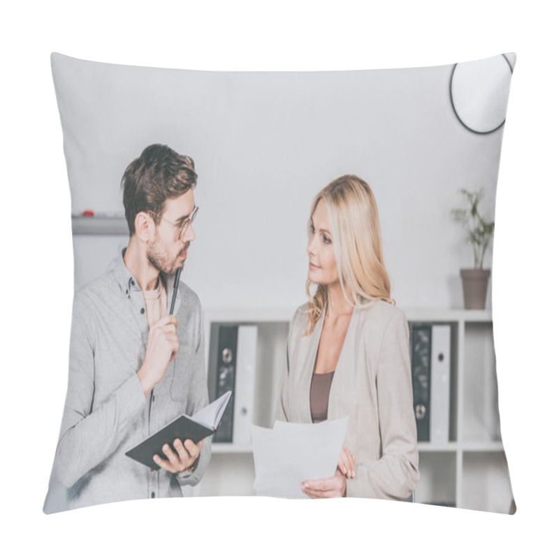 Personality  Focused Young Businessman Holding Notebook And Looking At Mature Businesswoman With Papers In Office Pillow Covers