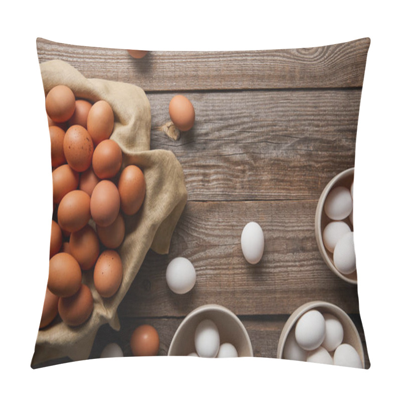 Personality   top view of chicken eggs in bowls on wooden table with cloth pillow covers