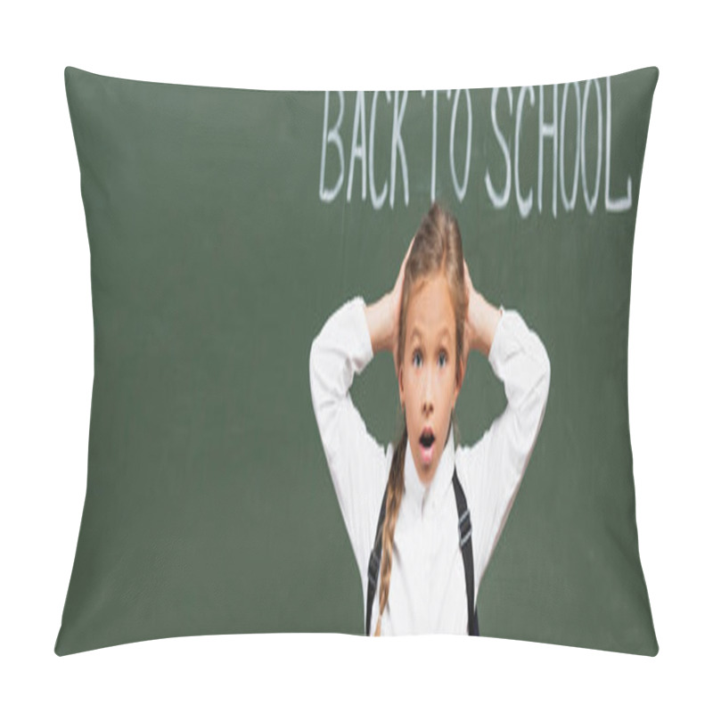 Personality  panoramic shot of shocked schoolgirl touching head near chalkboard with back to school inscription pillow covers
